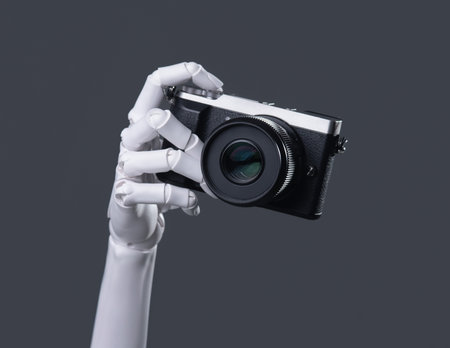 Robot Hand Holding a Digital Camera: AI Vision, Technology, and Future Photography Conceptの写真素材