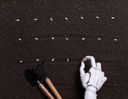 Robotic Hands Planting Seeds in Dark Fertile Soilの写真素材