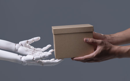 Human-Robot Interaction: The Exchange of a Brown Box in Automated Serviceの写真素材