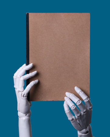 Robot Hands Holding a Blank Brown Notebookの写真素材