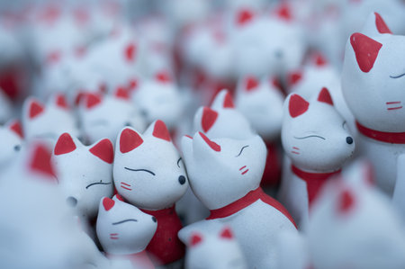 Ceramic Kitsune fox dolls lined up: Symbol of a Japanese shrineの写真素材
