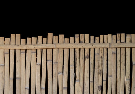 Natural bamboo wall: Asian style fence isolated on a black backgroundの写真素材