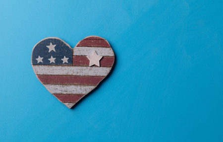 Rustic Wooden Heart with USA Flag Pattern on Blue Background for Independence Dayの写真素材