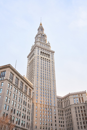 Cleveland, Ohio/USA - March 5th 2018: The Terminal Tower with blue sky and golden lighting. The terminal tower is a 52-story, landmark skyscraper located in Public Square in downtown Cleveland Ohio.のeditorial素材