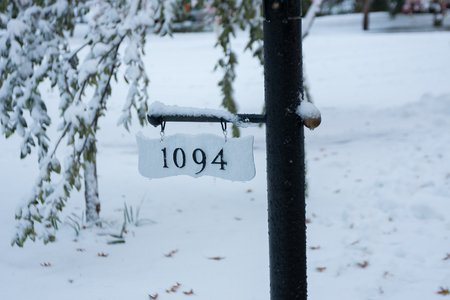 Street address with black lettering covered with snowの写真素材