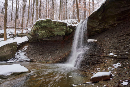 Waterfall in the forest. Winter landscape with a waterfall in the forest.の写真素材