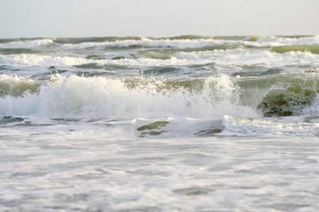Waves on the beach in the evening, closeup of photoの写真素材