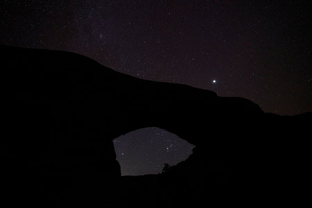 A starry night in Arches National Park. The north window arch is silhouetted against the beautiful sky.の写真素材