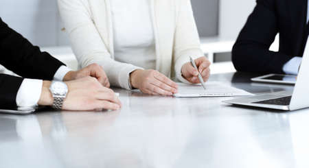 Business people discussing contract working together at meeting in modern office. Unknown businessman and woman with colleagues or lawyers at negotiationの写真素材
