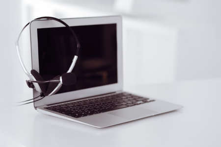 Call center and communication support, customer service help desk. VOIP headset on laptop computerの写真素材