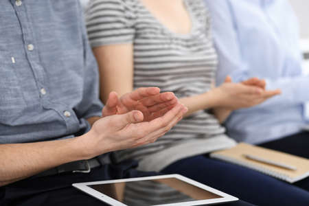 Business people clapping at meeting or conference, close-up of hands. Group of unknown businessmen...