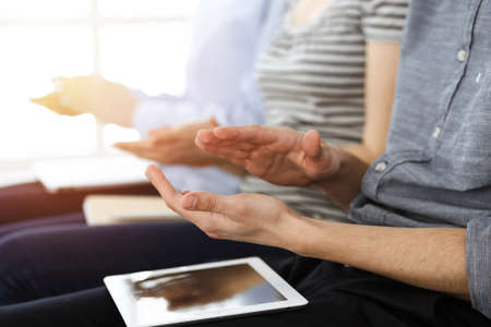 Business people clapping at meeting or conference, close-up of hands. Group of unknown businessmen...