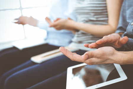 Business people clapping at meeting or conference, close-up of hands. Group of unknown businessmen...