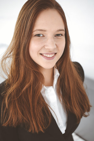 Business woman standing in white office. Student girl and success conceptの写真素材