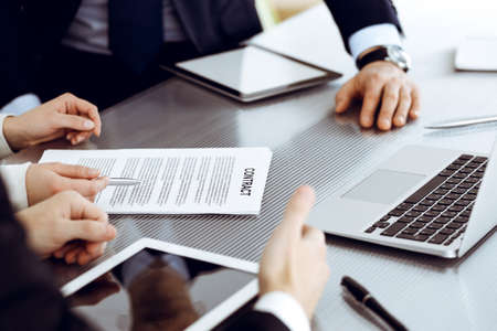Business people discussing contract working together at meeting in modern office. Unknown businessman and woman with colleagues or lawyers at negotiationの写真素材