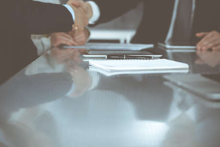 Business people shaking hands after contract signing in modern office. Teamwork and handshake...