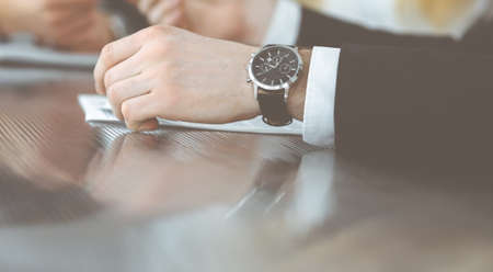 Unknown business people discussing questions of contract at meeting in modern office, close-up. Teamwork and partnership conceptの写真素材