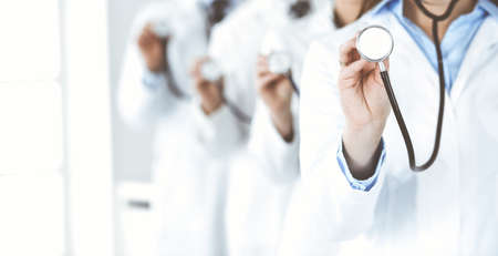 Group of doctors holding stethoscope head close-up. Physicians ready to examine and help patient. Medicine conceptの写真素材