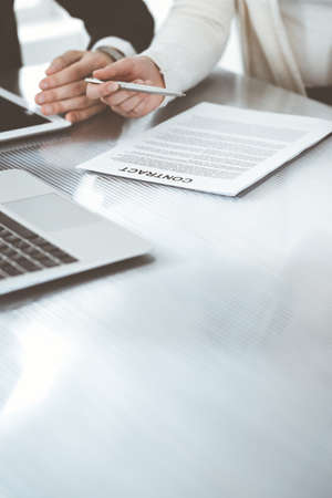 Business people discussing contract working together at meeting in modern office. Unknown businessman and woman with colleagues or lawyers at negotiationの写真素材