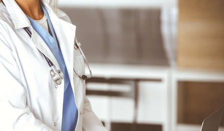 Unknown female physician using laptop computer, close-up. Woman-doctor at work in clinic. Medicine conceptの写真素材