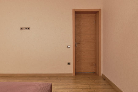 Wooden door in bedroom room interior. Laminate on the floor. Real Estate objects. Concept of hotel...