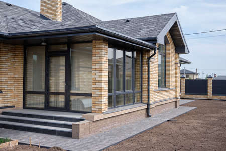 House with a roof from a bituminous tile. Bituminous tile for a roof. a roof from a bituminous tile.の写真素材