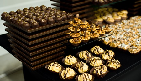 Many chocolate cookies with nuts and caramelの写真素材