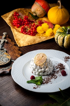 A Halloween Meal. A dish at a restaurant for Halloween celebrations. Black background, brick wall and wooden tableの写真素材