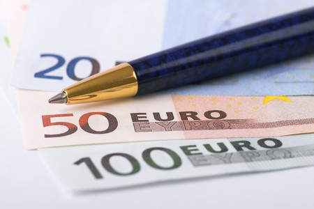 Euro banknotes and golden pen selective focusの写真素材