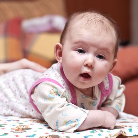 Portrait of a cute baby-girl with her mouth openの写真素材