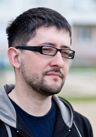 Portrait of a young male caucasian student with beard and glassesの写真素材