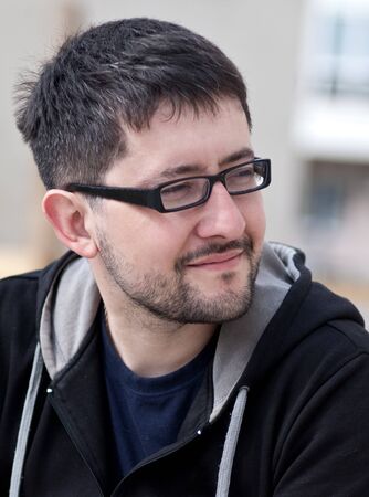 Portrait of a young male caucasian student with beard and glassesの写真素材