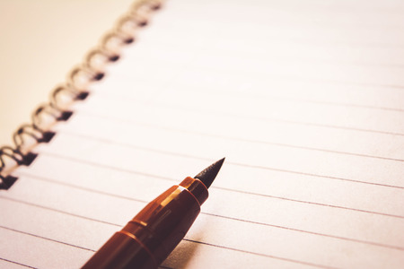 notebook on wooden tableの写真素材