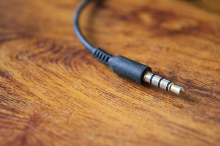 Earphone jack on abstract wooden backgroundの写真素材