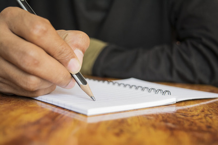 human hand writing a noteの写真素材