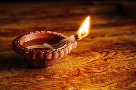 Diwali festival lamp on wooden backgroundの写真素材