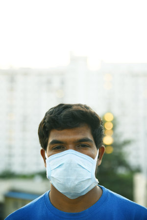Bengaluru,Karnataka,India -01-04-2020 : Masked man looking out with a hopeのeditorial素材
