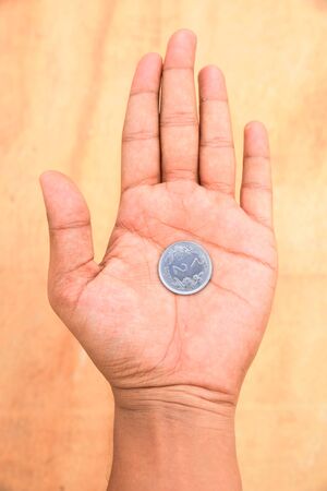 hand holding two rupee coin  - recessionの写真素材