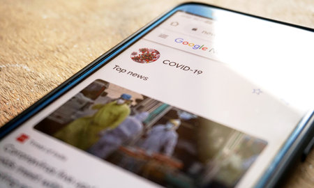 Bengaluru,Karnataka,India- May 11, 2020:serching covid-19 news on a smartphoneのeditorial素材