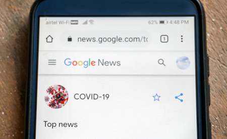 Bengaluru,Karnataka,India- May 11, 2020:serching covid-19 news on a smartphoneのeditorial素材