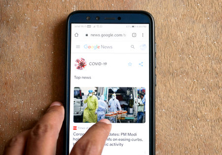 Bengaluru,Karnataka,India- May 11, 2020:serching covid-19 news on a smartphone