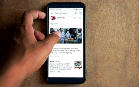 Bengaluru,Karnataka,India- May 11, 2020:serching covid-19 news on a smartphone