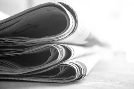 rolled up newspaper stack backgroundの写真素材