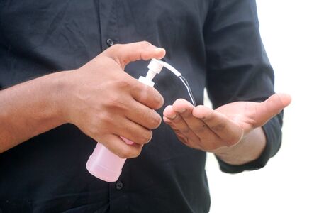 man applying sanitizer to handsの写真素材