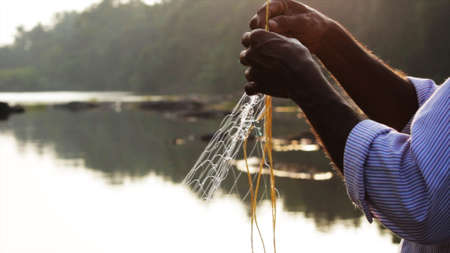 Indian man preparing the fishing netの写真素材