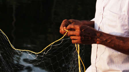 Indian man preparing the fishing netの写真素材