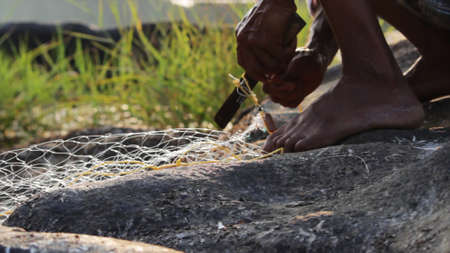 Indian man preparing the fishing net