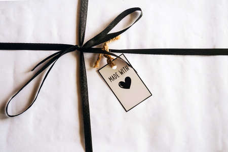 gift box with tag on wooden background