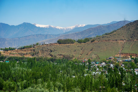 Village in the mountains on a background of snow-capped peaksの写真素材