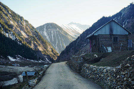 Mountain landscape with old wooden house in the middle of the valley